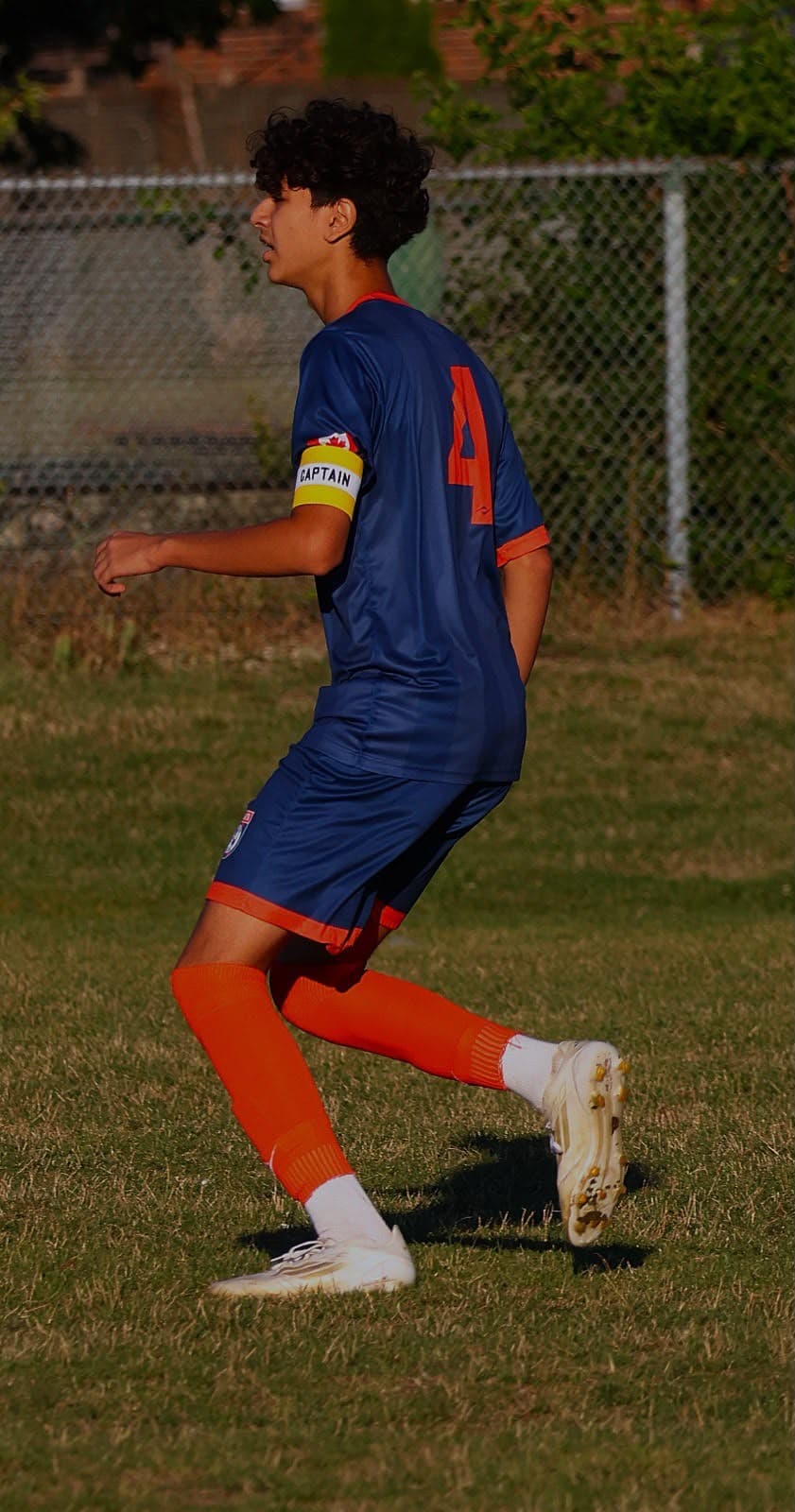 Radin Hajipour wears a Canadian flag captain's armband during youth football training in Toronto
